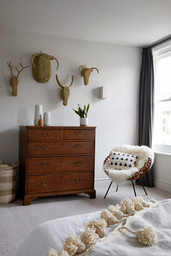 Large eclectic master carpeted and beige floor bedroom photo in London with white walls