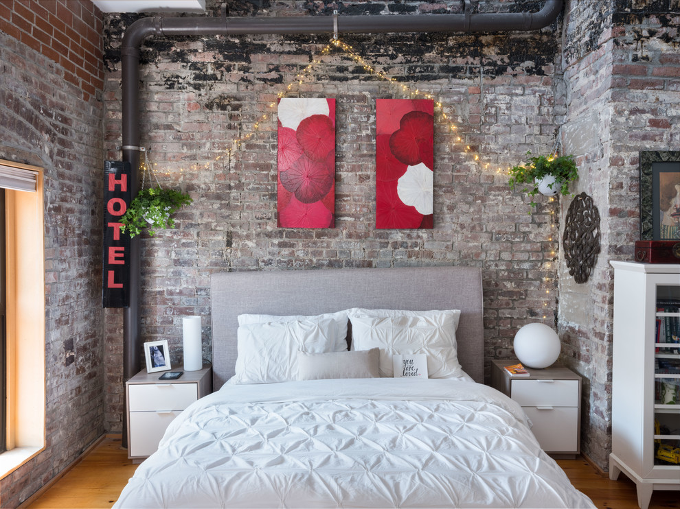 Danish medium tone wood floor and brown floor bedroom photo in New York