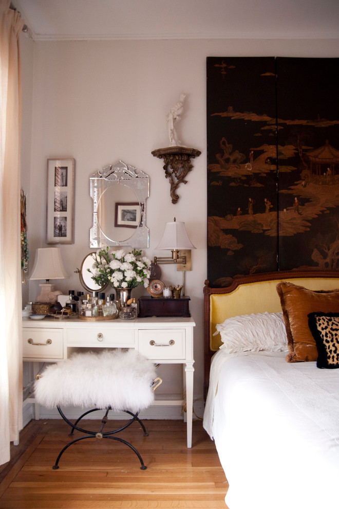 Inspiration for a bohemian master bedroom in New York with medium hardwood flooring.