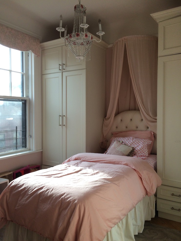 Bedroom - small traditional guest medium tone wood floor bedroom idea in New York with pink walls and no fireplace