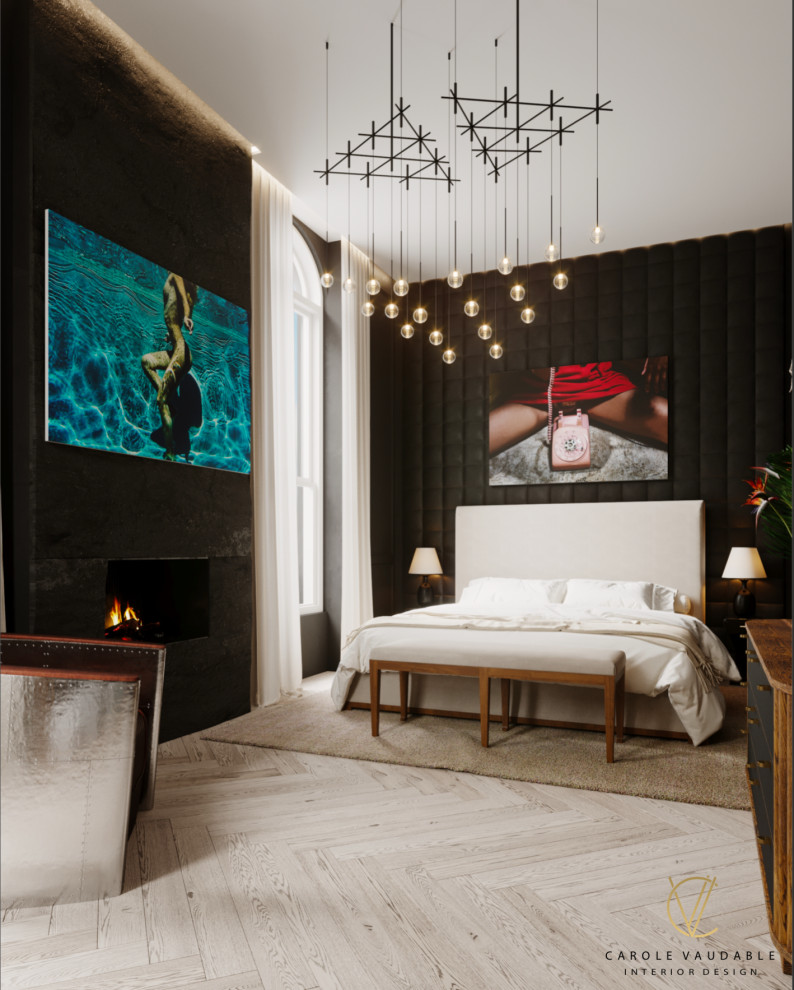 На фото: хозяйская спальня среднего размера в современном стиле с черными стенами, светлым паркетным полом, стандартным камином, фасадом камина из камня, серым полом, кессонным потолком и панелями на части стены с