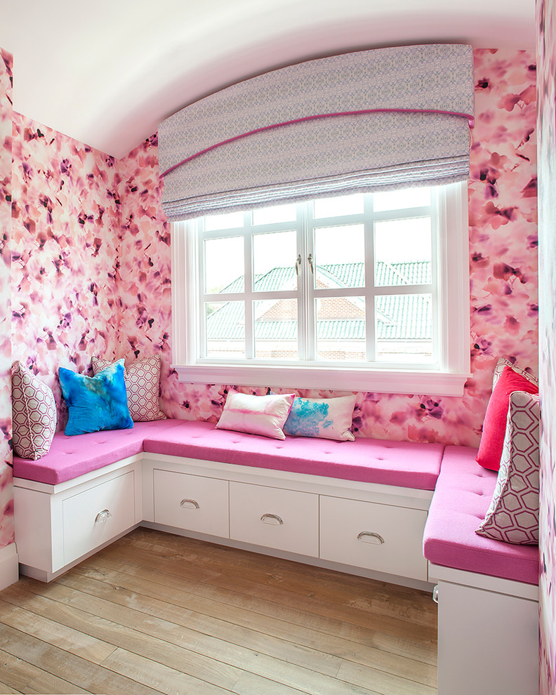 Inspiration for a large contemporary master bedroom in New York with pink walls and light hardwood flooring.