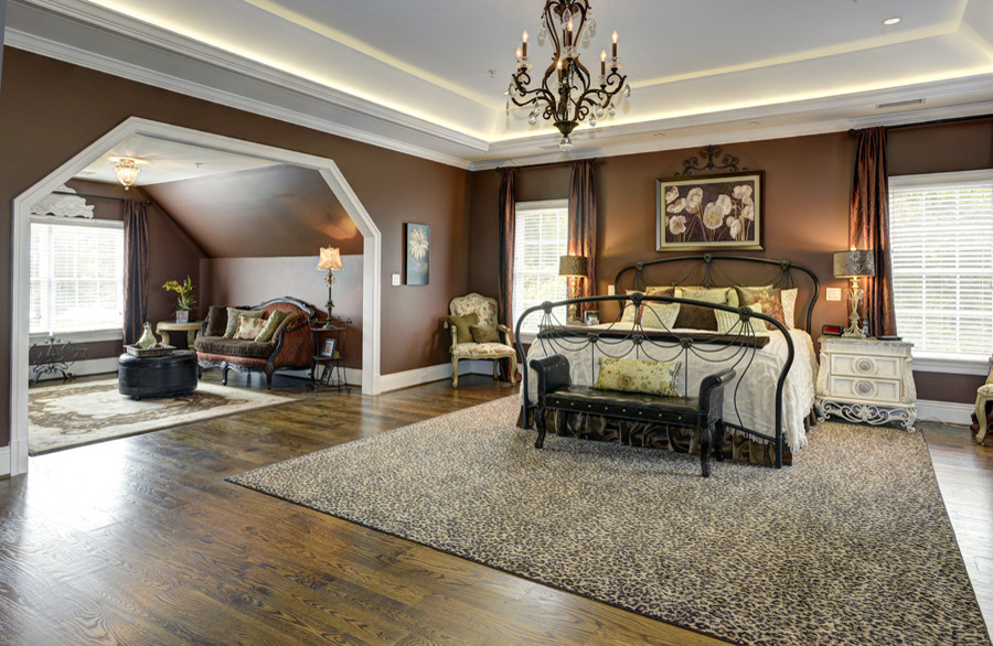 Idee per una grande camera matrimoniale tradizionale con pareti marroni, pavimento in legno massello medio e pavimento marrone