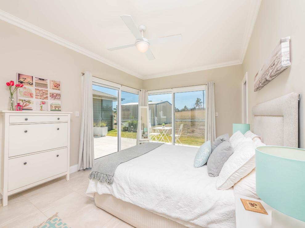 Coastal guest bedroom in Sydney with beige walls and beige floors.