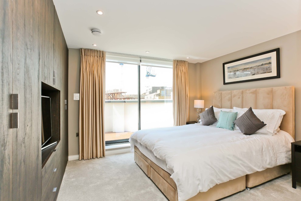 Photo of a classic guest bedroom in London with beige walls, carpet and beige floors.