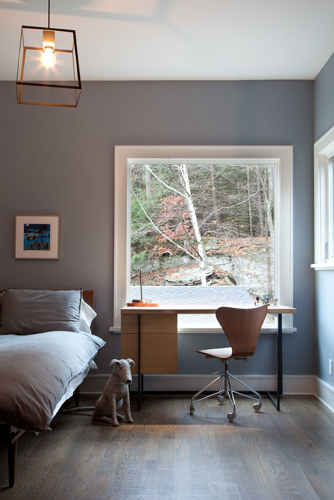 Bild på ett lantligt sovrum, med grå väggar och mörkt trägolv