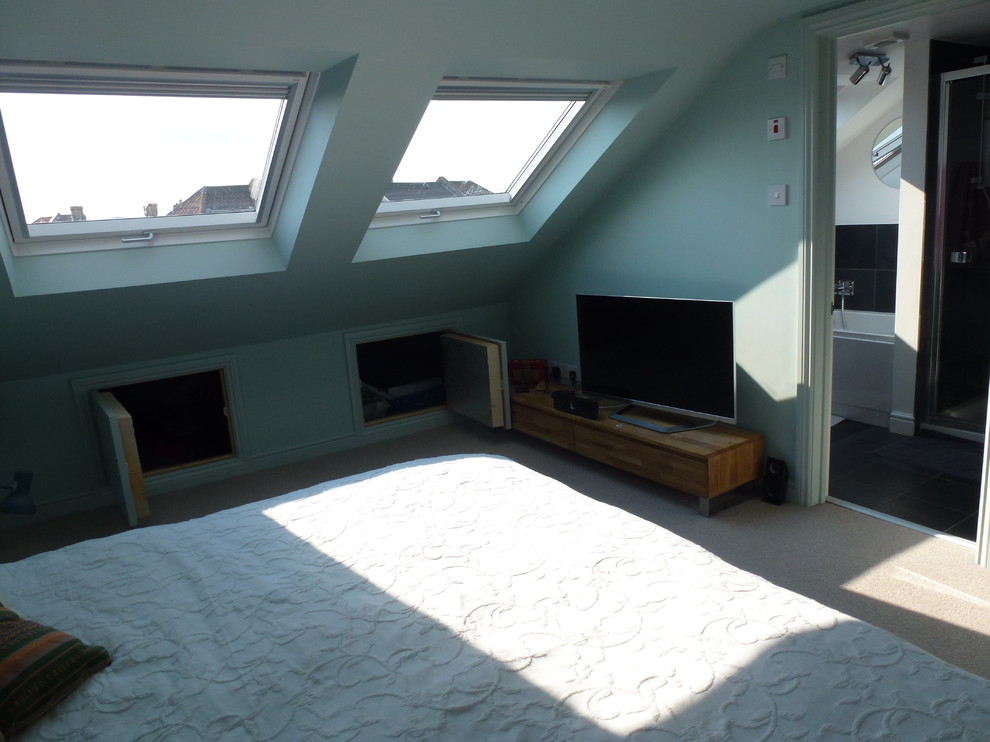 Inspiration for a medium sized modern mezzanine bedroom in Gloucestershire with blue walls, carpet and no fireplace.