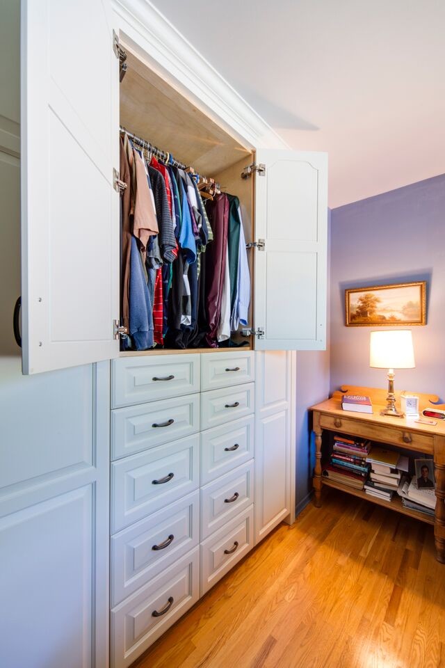 Medium sized classic wardrobe in Toronto with medium hardwood flooring.
