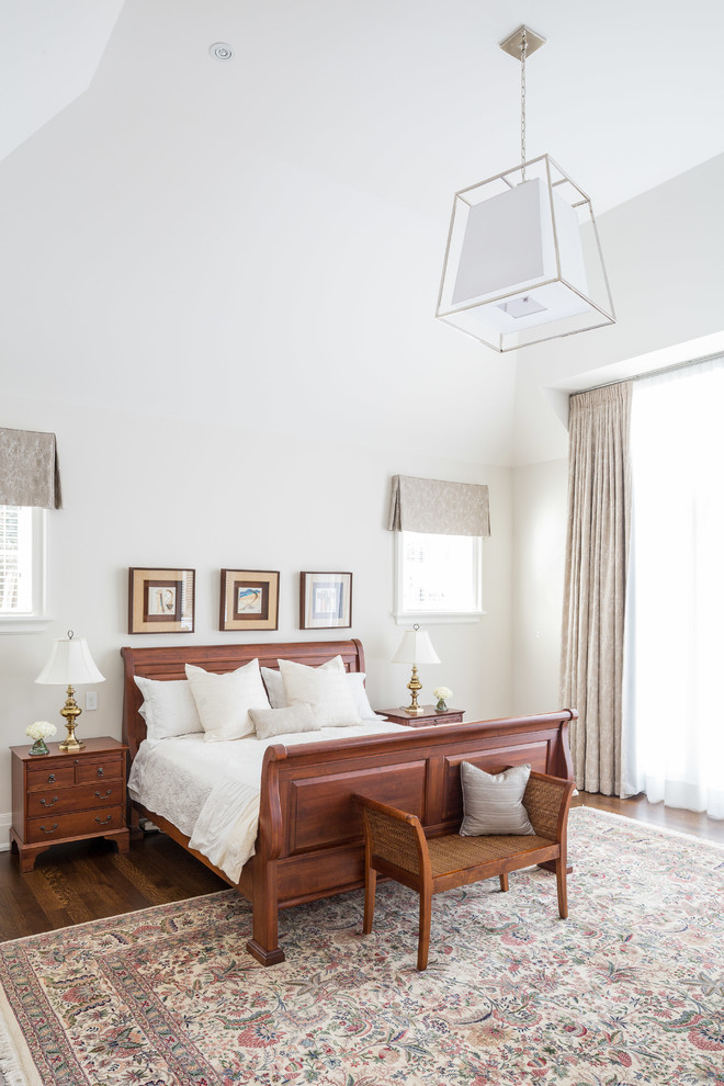 Design ideas for a large traditional master bedroom in Toronto with white walls and dark hardwood flooring.