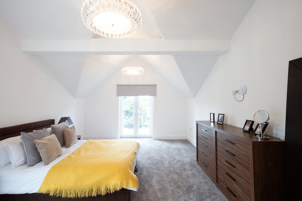 Photo of a large contemporary master bedroom in Berkshire with white walls, carpet and grey floors.