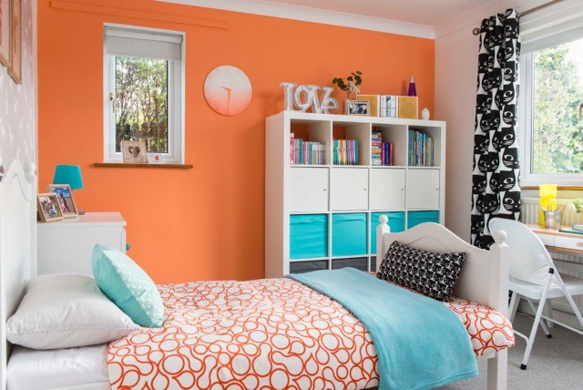 Medium sized contemporary guest bedroom in Devon with orange walls, carpet and grey floors.