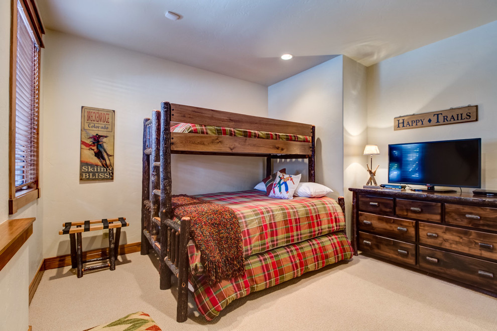Medium sized rustic master bedroom in Denver with carpet.
