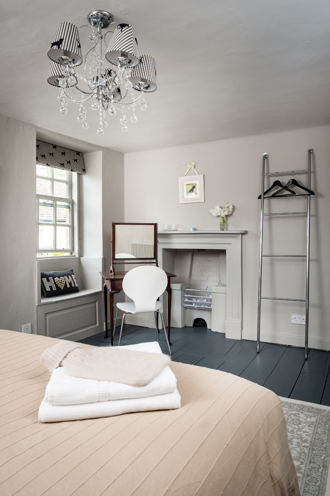 This is an example of a farmhouse guest bedroom in Surrey with beige walls.