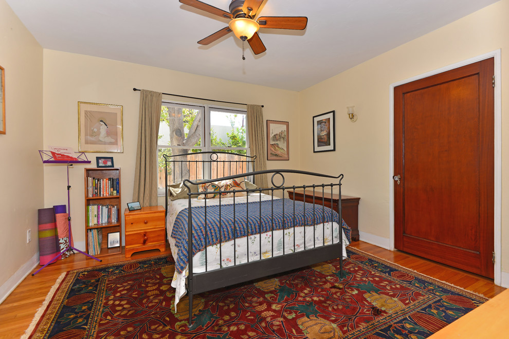 Inspiration for a medium sized mediterranean guest bedroom in San Diego with beige walls and medium hardwood flooring.
