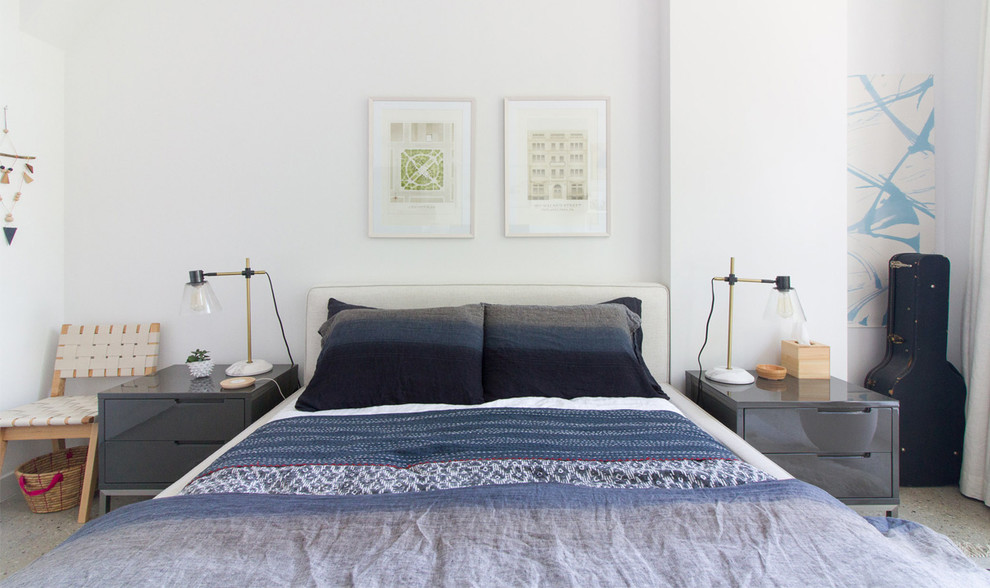 Example of a mid-sized eclectic master concrete floor bedroom design in New York with white walls