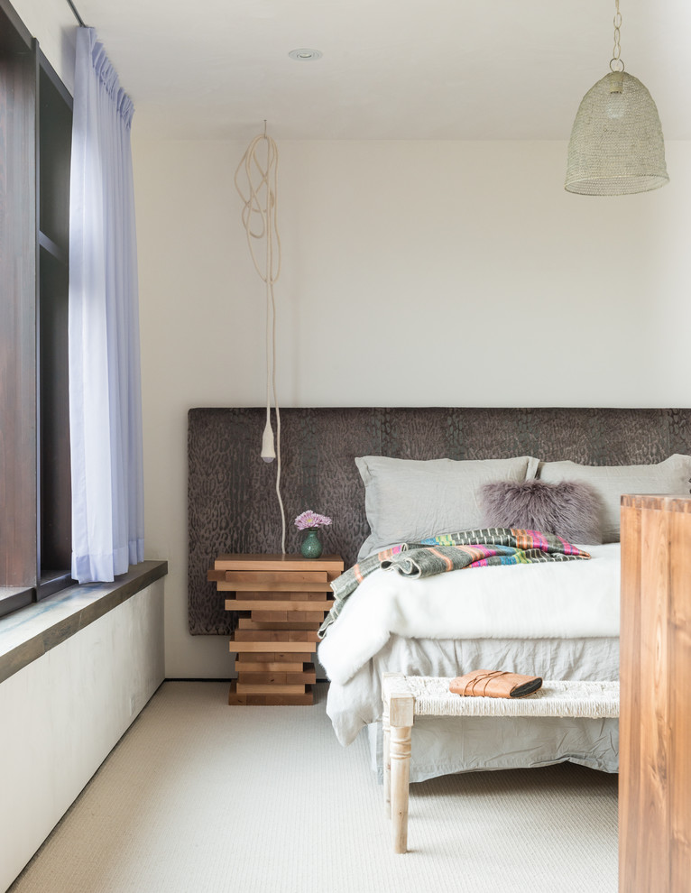 Contemporary bedroom in Other with white walls and carpet.