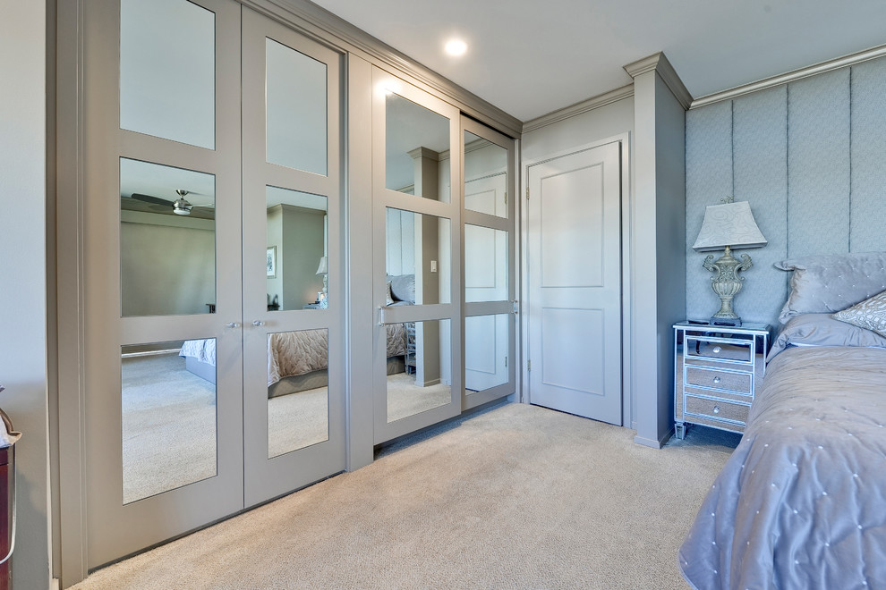Inspiration for a large contemporary master carpeted and beige floor bedroom remodel in Calgary with beige walls and no fireplace