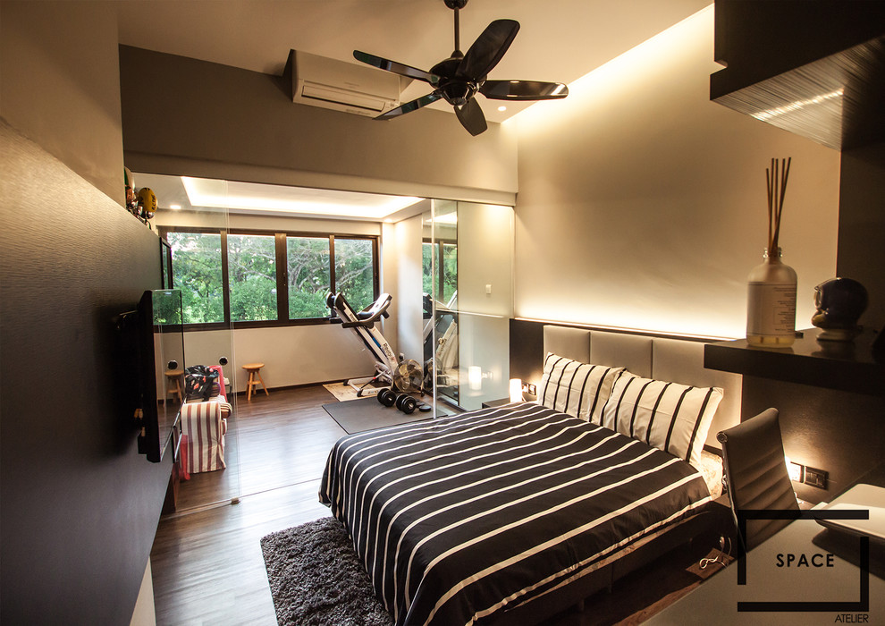Large modern guest bedroom in Singapore with grey walls and dark hardwood flooring.