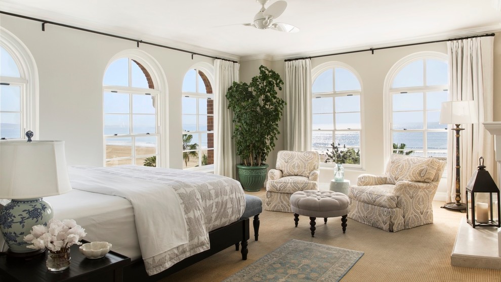 Design ideas for a large coastal master bedroom in Los Angeles with white walls and carpet.