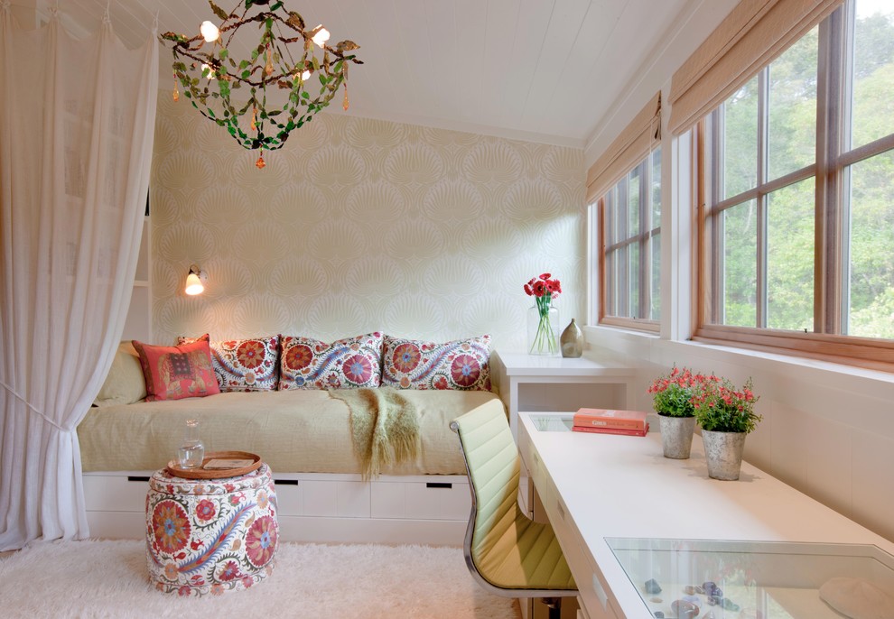 This is an example of a large bohemian guest bedroom in San Francisco with no fireplace, beige walls and carpet.