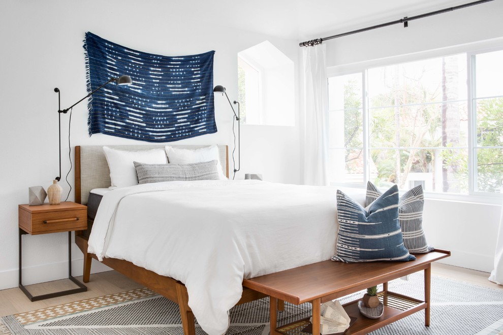 Design ideas for a medium sized nautical master bedroom in Orange County with white walls, light hardwood flooring and beige floors.
