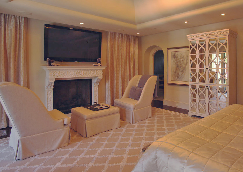 Photo of a medium sized mediterranean guest bedroom in San Francisco with beige walls, dark hardwood flooring, a standard fireplace and a stone fireplace surround.