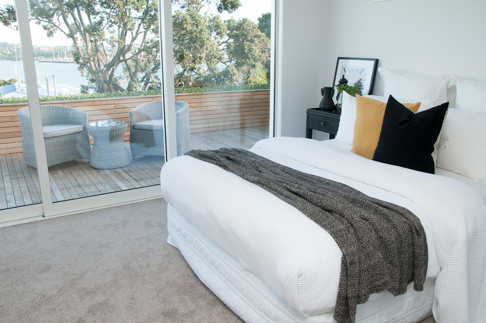 Ejemplo de dormitorio principal moderno de tamaño medio sin chimenea con paredes blancas, moqueta y suelo beige