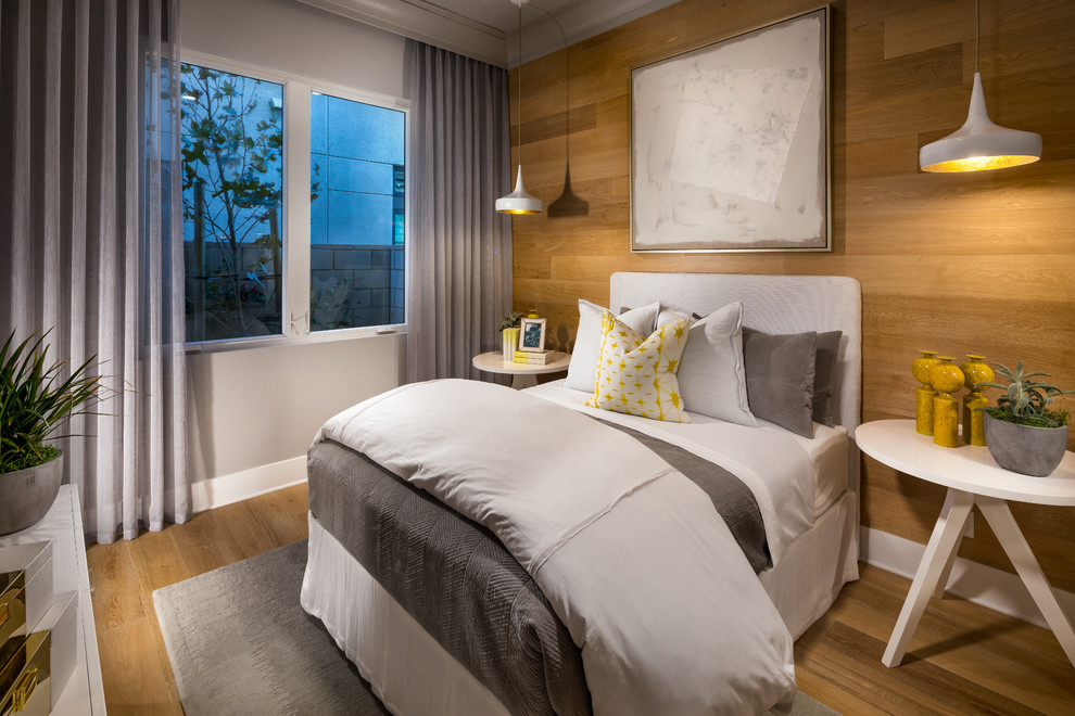 Großes Modernes Gästezimmer ohne Kamin mit weißer Wandfarbe und braunem Holzboden in Orange County