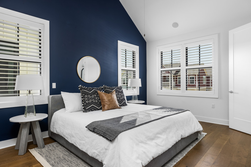 Inspiration for a mid-sized cottage master medium tone wood floor and beige floor bedroom remodel in Austin with blue walls