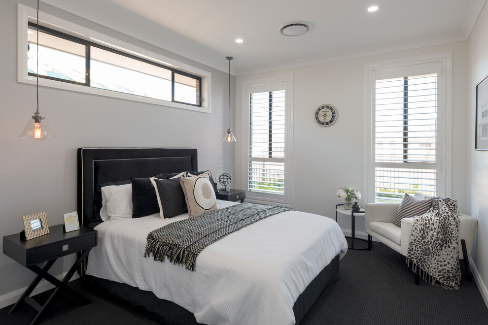Стильный дизайн: гостевая спальня (комната для гостей) в современном стиле с бежевыми стенами, ковровым покрытием и черным полом - последний тренд