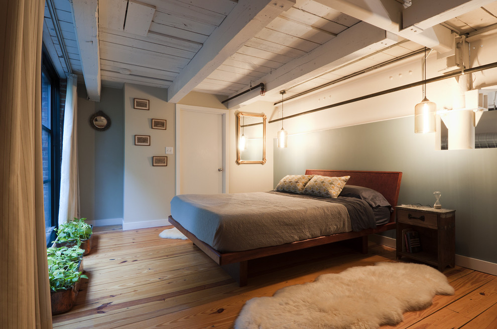 Bedroom - industrial medium tone wood floor bedroom idea in Boston with gray walls