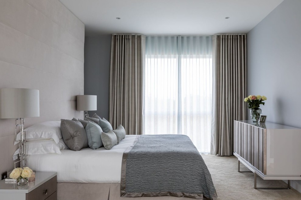 Inspiration for a large contemporary master carpeted and beige floor bedroom remodel in Cambridgeshire with blue walls