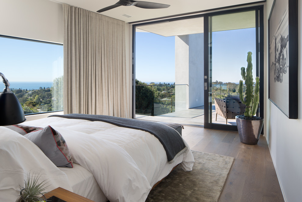 Inspiration for a large modern master dark wood floor and brown floor bedroom remodel in San Diego with gray walls