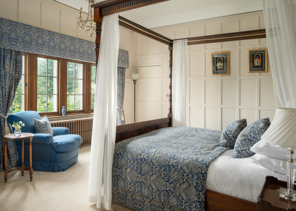 На фото: спальня в классическом стиле с бежевыми стенами, ковровым покрытием, бежевым полом и панелями на части стены