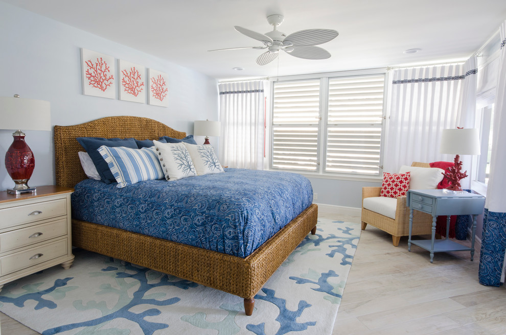 Large coastal master bedroom in Miami with blue walls and ceramic flooring.
