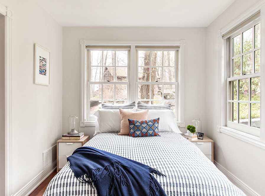 Bedroom - mid-sized contemporary guest medium tone wood floor bedroom idea in New York with white walls and no fireplace