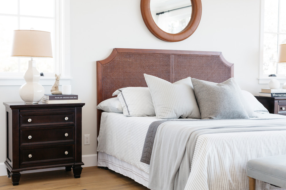 Foto de dormitorio campestre con paredes blancas, suelo de madera en tonos medios y suelo marrón