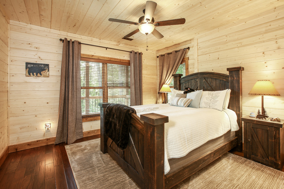 Bedroom - rustic dark wood floor and brown floor bedroom idea in New Orleans with beige walls