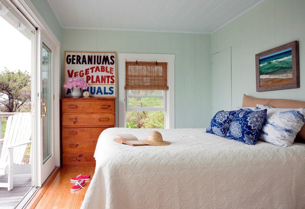 Modelo de dormitorio principal costero pequeño con paredes verdes y suelo de madera clara