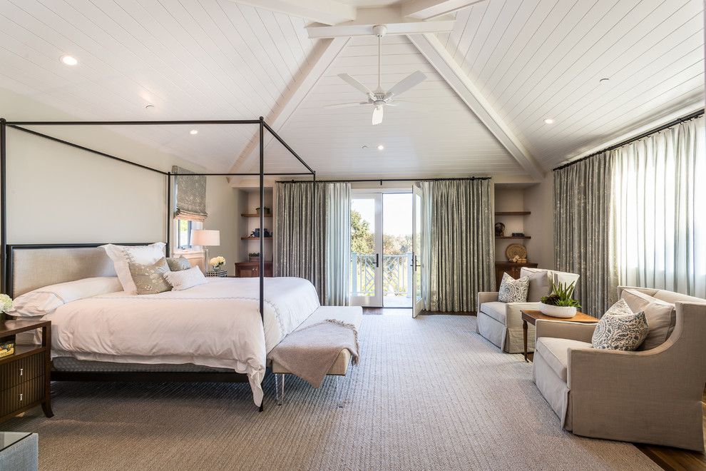 This is an example of a beach style bedroom in Los Angeles with beige walls, medium hardwood flooring and brown floors.