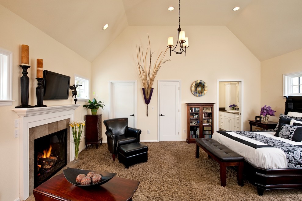 Large elegant loft-style carpeted bedroom photo in Other with a standard fireplace, a tile fireplace and white walls