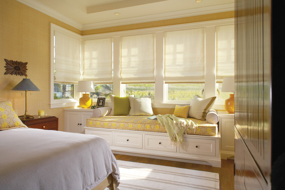Inspiration for a timeless medium tone wood floor bedroom remodel in Orange County with beige walls and no fireplace
