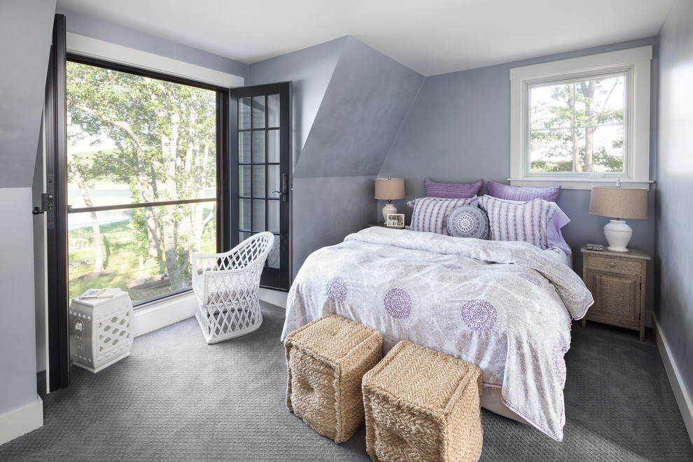 This is an example of a traditional bedroom in Portland Maine with carpet, grey walls and feature lighting.