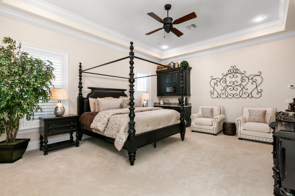 Large tuscan master carpeted bedroom photo in Orlando with white walls and no fireplace