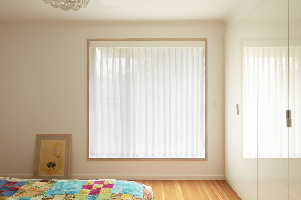 Bedroom - contemporary master light wood floor bedroom idea in Perth with white walls