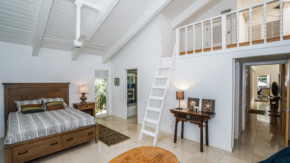 Immagine di una camera da letto tropicale con pareti bianche, nessun camino e pavimento beige