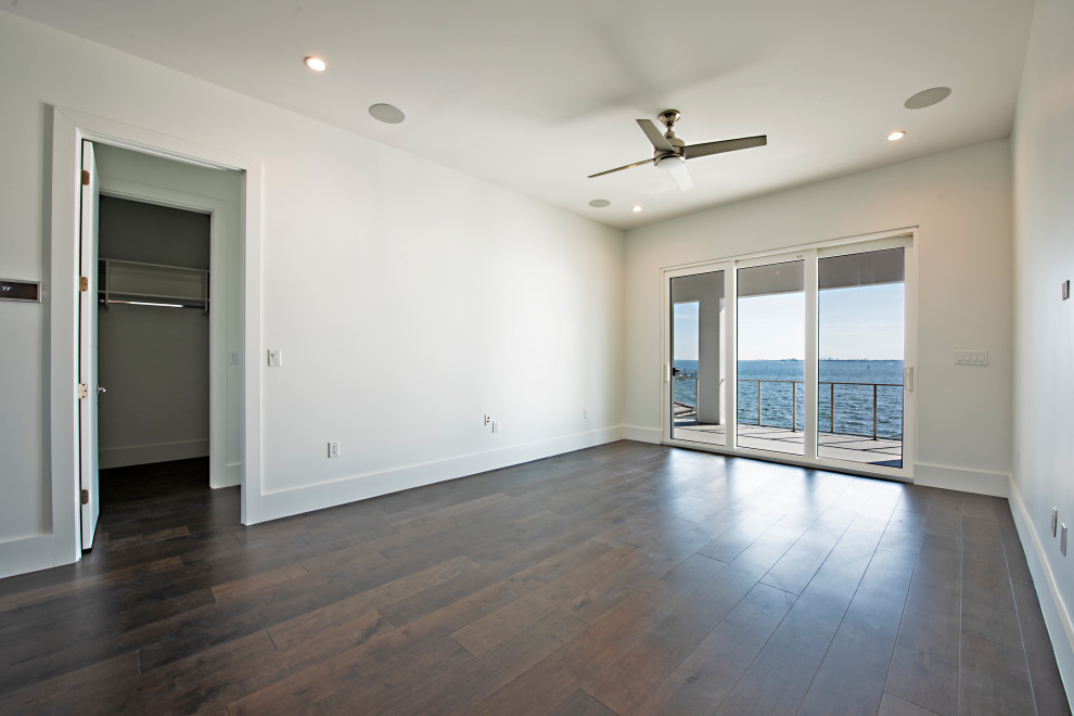 Inspiration for a large contemporary guest bedroom in Tampa with white walls, dark hardwood flooring and no fireplace.