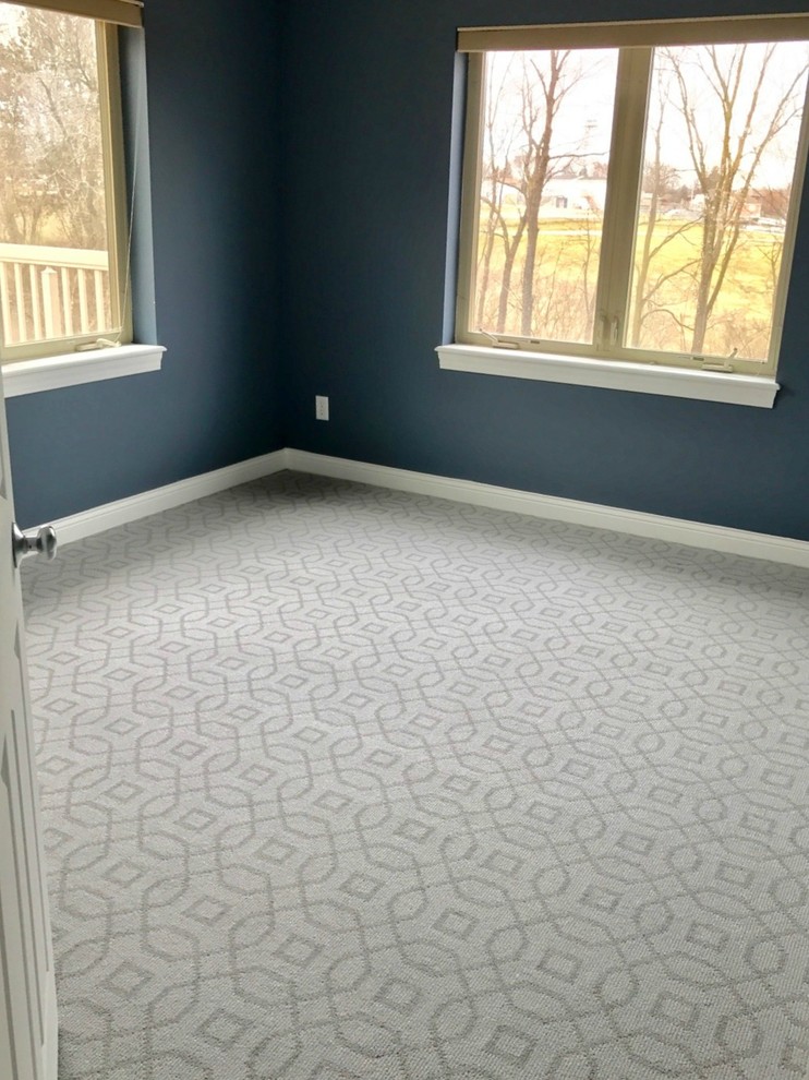 Medium sized traditional master bedroom in Cedar Rapids with blue walls and carpet.