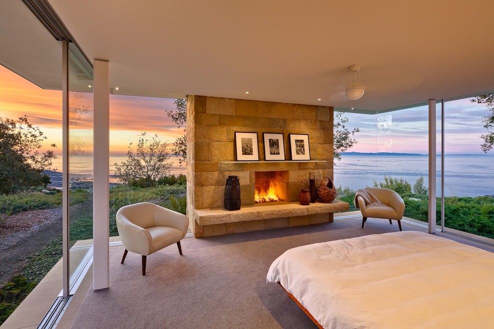Inspiration for a modern carpeted bedroom remodel in Santa Barbara with a standard fireplace and a stone fireplace