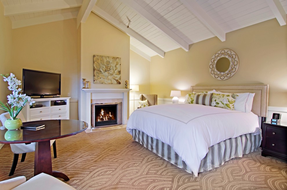 Inspiration for a large transitional master carpeted bedroom remodel in San Francisco with beige walls, a standard fireplace and a tile fireplace